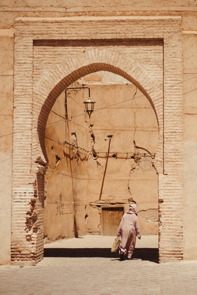 woman walking in djellaba in the Kasbah Marrakech Morocco